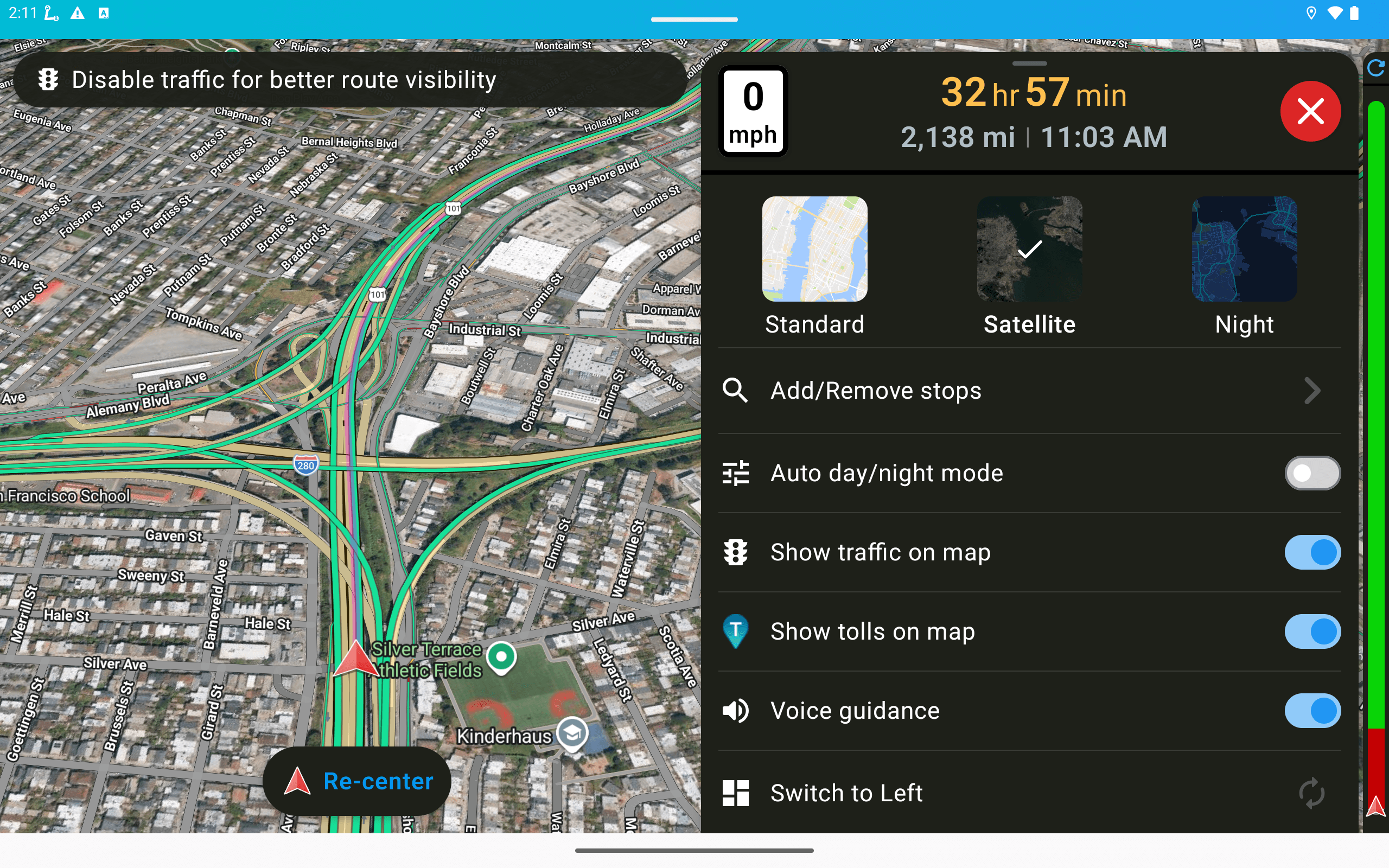 The menu: add or remove stops, auto day and night mode, traffic on map, tolls on map, voice guidance, and Troubleshoot / Report issues. Remaining time, miles and ETA stay in view.